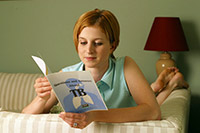 Photo: Woman reading brochure about TB