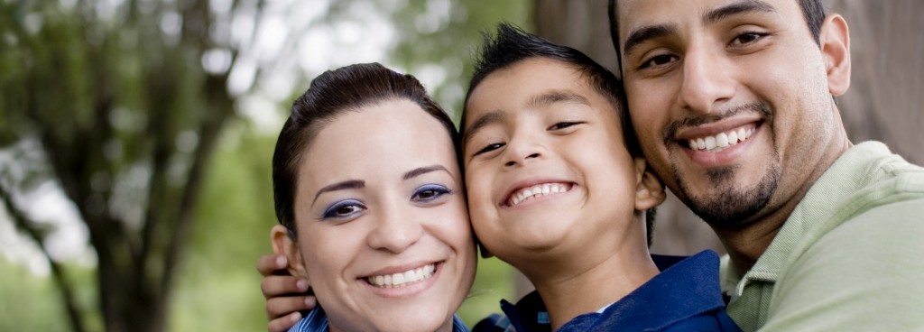 Mother, young son, and father smiling  