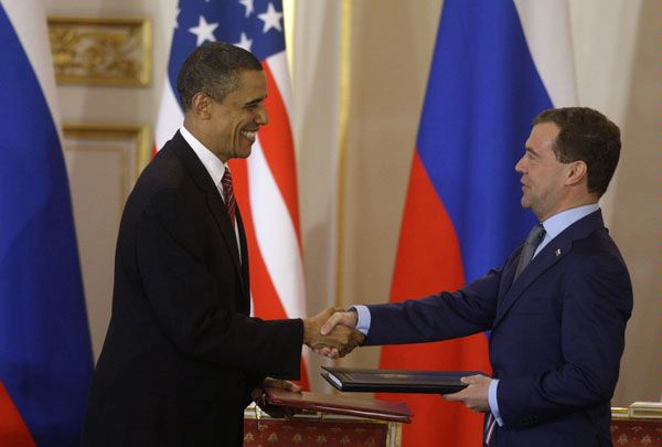 U.S. President Barack Obama, left, shakes hands with his Russian counterpart Dmitry Medvedev, right, after signing the newly completed New START treaty reducing long-range nuclear weapons at the Prague Castle in Prague, Czech Republic, Thursday, April 8, 2010.

