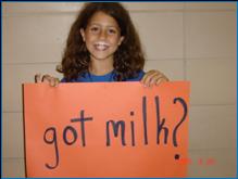 Image of girl holding a sign that says, "Got Milk?"