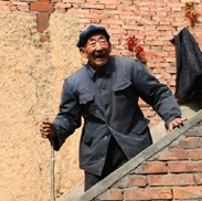 Elder Asian man walking down stairs