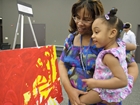 Mother and girl with painting