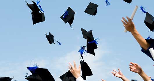 Mortarboards tossed in the air at a graduation ceremony