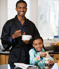 Father and Daughter eating ceral