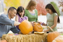 family carving pumpkins together
