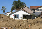 home surrounded by mud debris