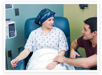 A cancer patient receives treatment from her doctor
