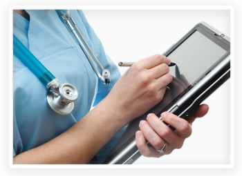 A nurse uses a tablet laptop to record patient information