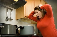 Frustrated women looking at pots on stove