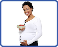 pregnant woman with bowl of fruit