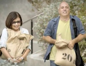 Photograph of a woman and man carrying a 10 and 20 pound bag.