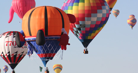 A cluster of color fills the sky during the first mass ascension at the 41st annual Albuquerque International Balloon Fiesta.