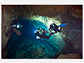 Cave divers diving in a submarine lava tube cave in the Canary Islands