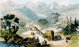 Wagon train of women, men, and children, moving through the mountains, Published in: American women : a Library of Congress guide for the study of women's history and culture in the United States
