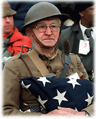 Veteran holding a folded flag.