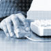 Photo of man reading document at desk