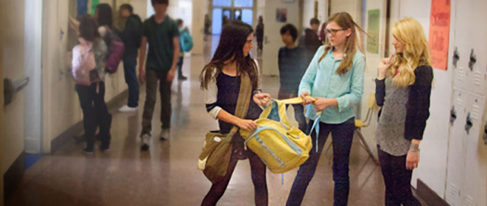 A student being bullied while others helplessly watch