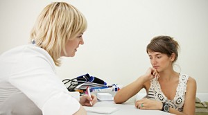 A nurse talks with an upset teen