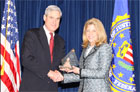 Megan O'Bryan accepts the award from FBI Director Mueller.