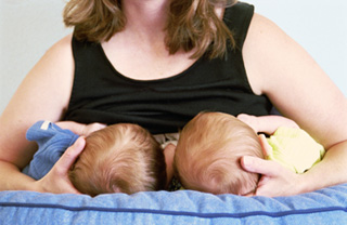 woman breastfeeding twins at the same time