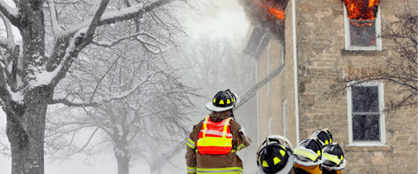 Firemen trying to put out a house that is on fire