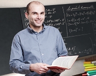 A teacher stands in a classroom