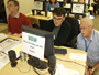 a photo of David Anderson, Dr. Ruben Baler, and Dr. Barry
                Hoffer gathered around a computer.