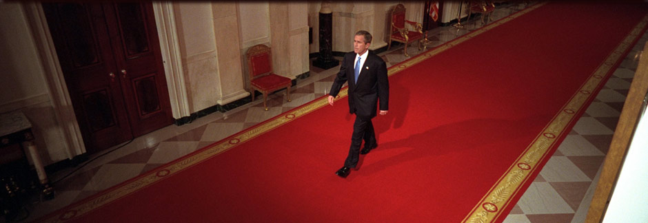 President George W. Bush walks through Cross Hall to the East Room of the White House, October 11, 2001. (P8468-08)