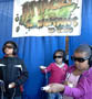 Kids play the 3-D game Attack of the S. mutans! at the USA Science & Engineering Expo.