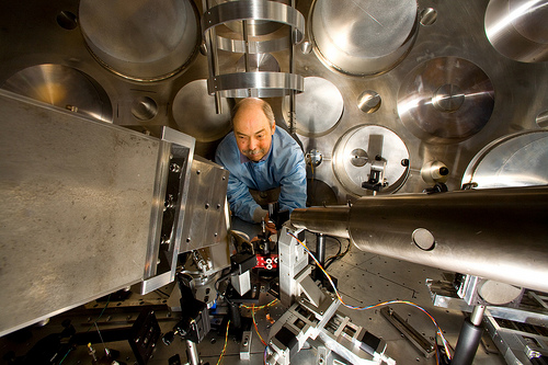 Scientist adjusts diagnostics for an experiment at Trident
