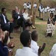 President George W. Bush and First Lady Laura Bush applaud after a theatrical performance by members of the Lycee de Kigali 'Anti-AIDS Club,' February 19, 2008, ouside of the school in Kigali, Rwanda. (P021908SC-0690)