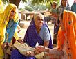 n elderly woman advises young women in her village to space their children, India.