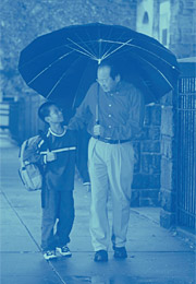 Image of father and son walking in the rain