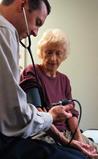 Photo of woman having blood pressure taken. - Click to enlarge in new window.