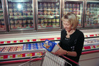 A woman reading the Nutrition Facts Label - Click to enlarge in new window.