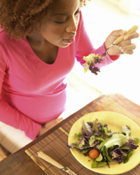 Photo: A woman eating a healthy salad.