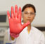 Scientist holding up gloved hand