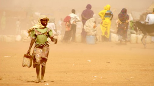 Girl struggles against sand storm in Darfur refugee camp, Sudan, Apr. 20, 2007. [AP File]