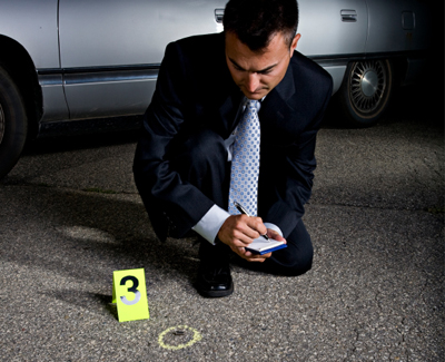 Investigator reviewing crime scene