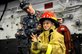 Navy Petty Officer 3rd Class Justin Enlow helps a child put on his fire helmet in the hangar bay of the amphibious assault ship USS Makin Island during a ship tour as part of San Francisco Fleet Week 2012 in San Francisco, Oct. 7, 2012. The event brings more than 2,500 sailors, Marines and Coast Guardsmen from four ships to the city to highlight the personnel, technology and capabilities of the sea services. U.S. Navy photo by Seaman Ethan Tracey