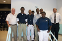 Pastor Brock Shiffer (far left) and Chris Himmel (far right) from the Greater Homestead /Florida City Chamber of Commerce's Military Affairs Committee thanked Homestead Job Corps students for their work on re-building the roof of a local church. Click for a larger image.