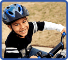 boy on bike wearing helmet