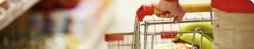 Woman pushing shopping cart in grocery store