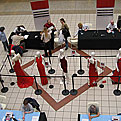 A birds-eye view of the 2008 Road Show set up, with mannequins wearing formal red dresses, and a crowd of people visiting the blood pressure stations set up on the periphery of the dress display