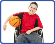 Boy in a wheelchair holding a basketball.