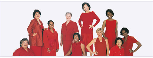 10 women of different ethnicities in red dresses and red suits, sitting and standing.