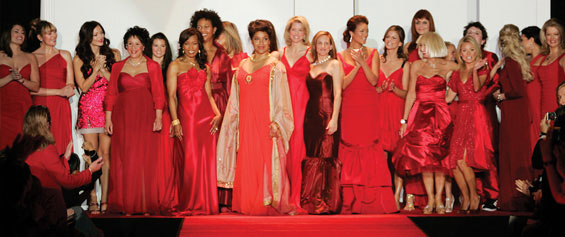 23 women in beautiful red dresigner dresses, including Phylicia Rashad standing center stage, take a final bow at the end of The Heart Truth's 2007 Fashion Show.