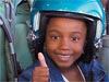 Girl with flight helmet on giving a thumbs up