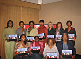 11 women are grouped together holding their speakers kit from the Jackson, Mississippi Champions training class. 
