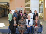 Ten women from the Wilmington Champions sit and stand together.